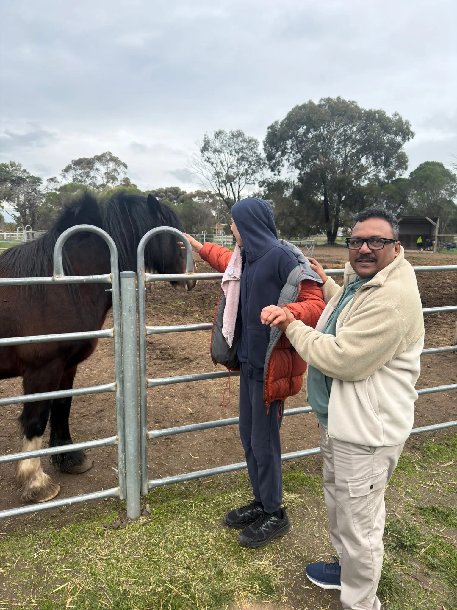 A participant feeding and interacting with a horse during a community farm outing