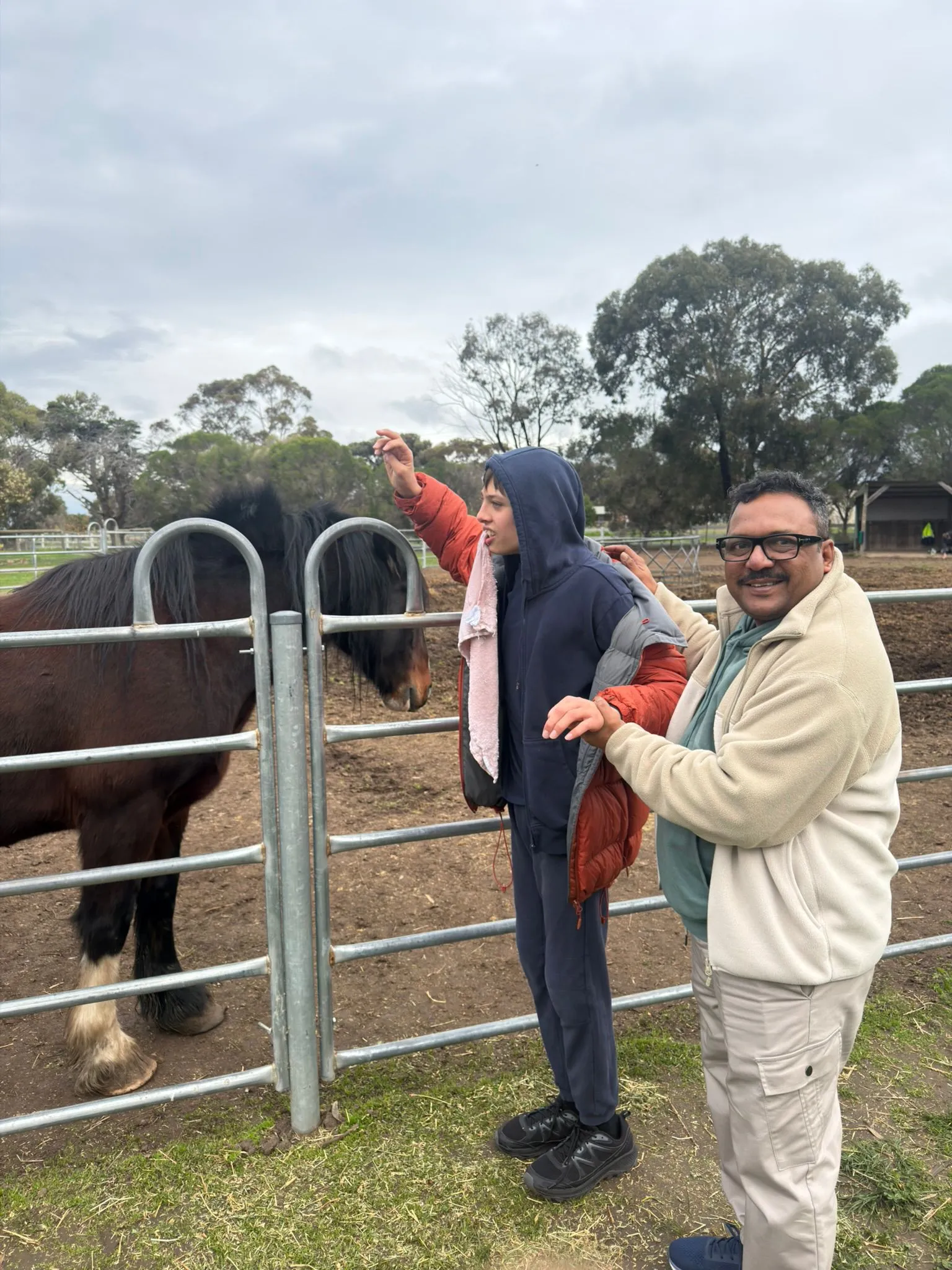 A participant standing with a horse during a community farm visit