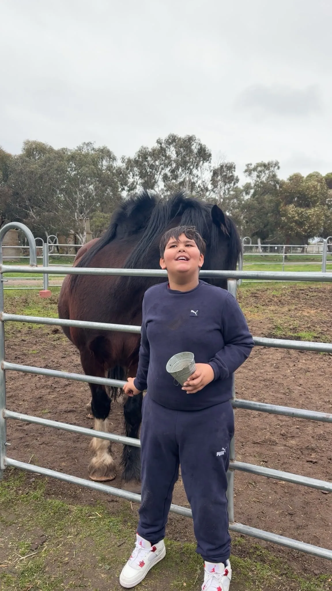A participant feeding and interacting with a horse during a community farm outing