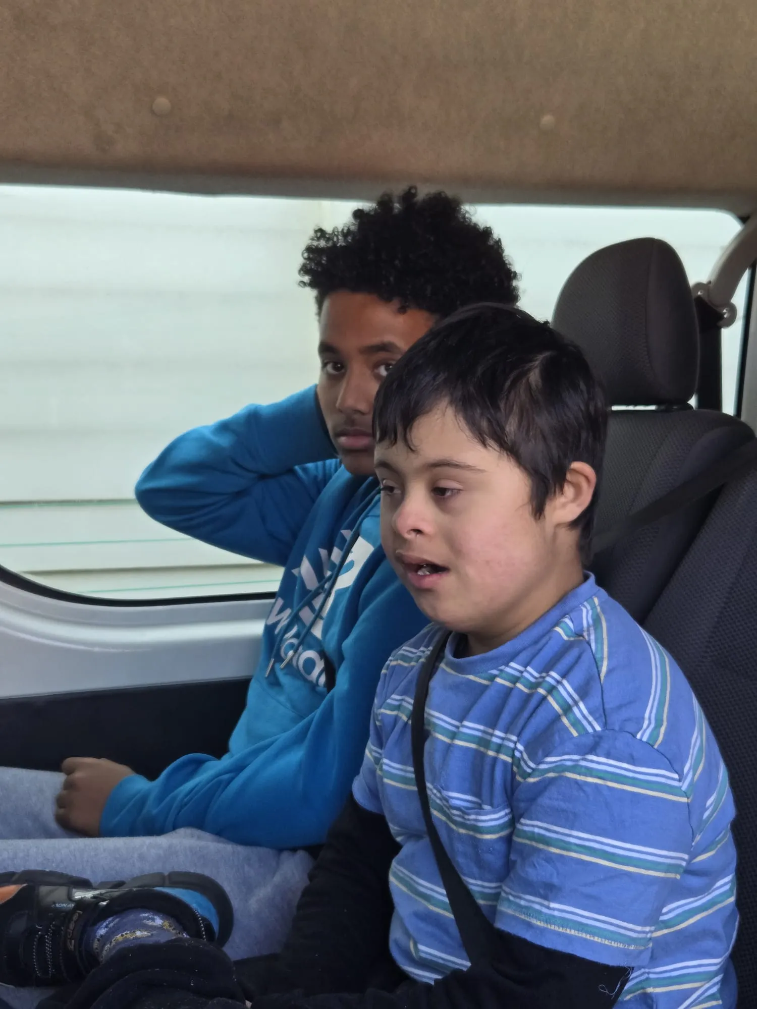 Participants seated together during transport as part of a community outing