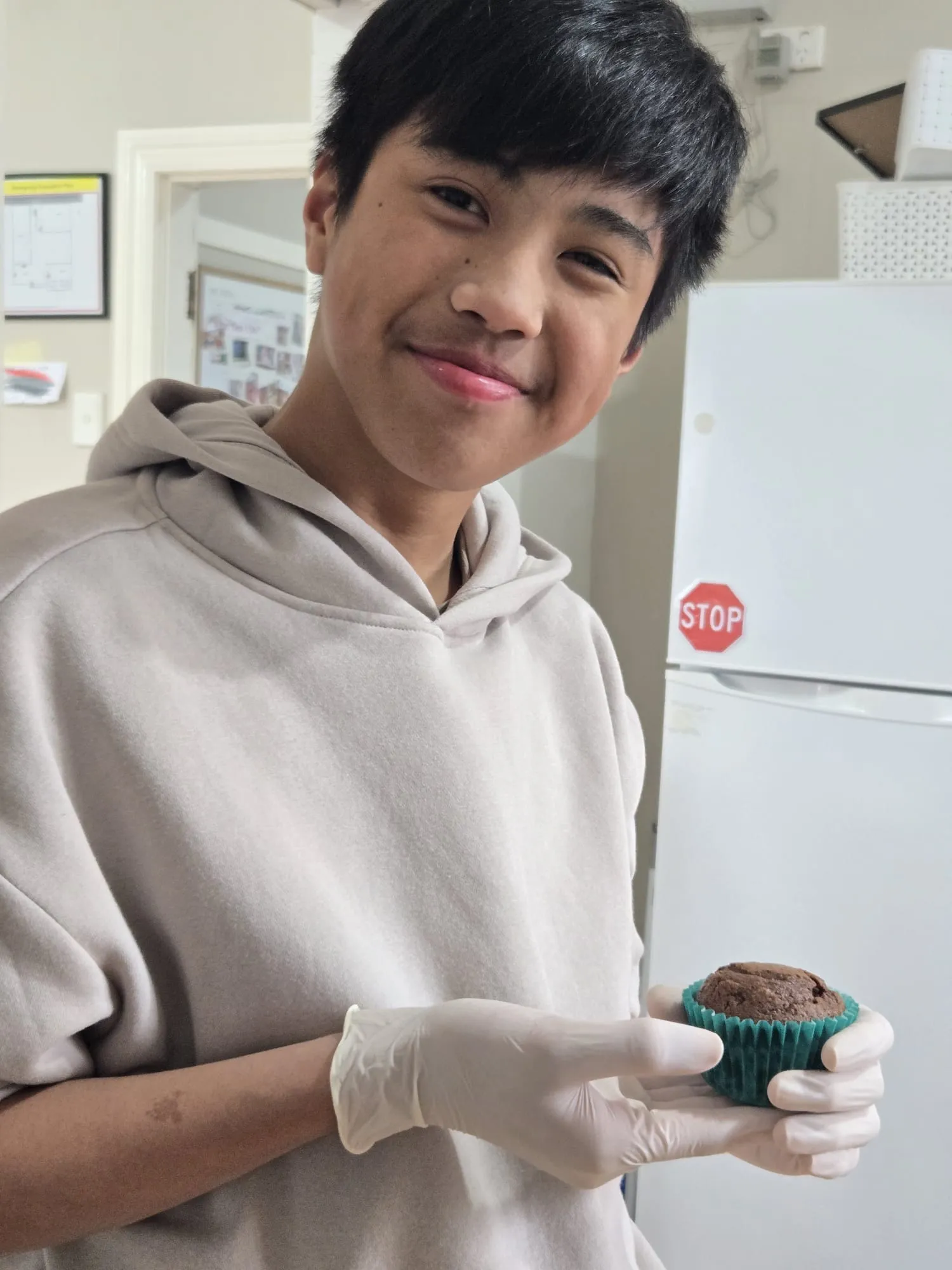 A participant holding a freshly baked cupcake made during a cooking session