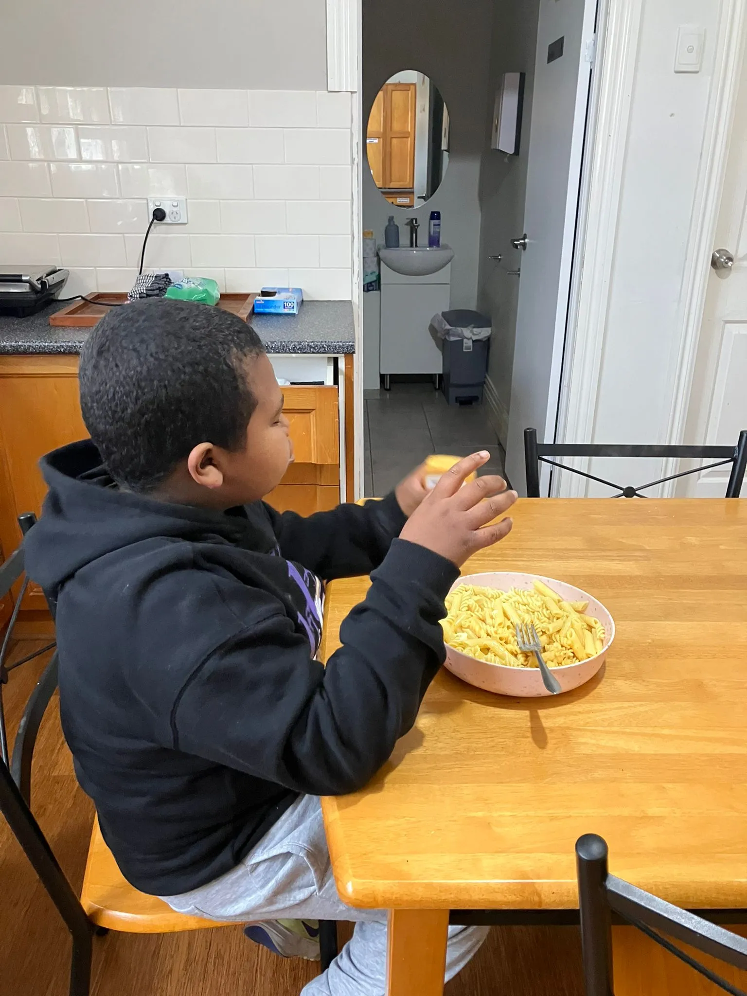 A participant preparing ingredients at the kitchen counter during a life skills session