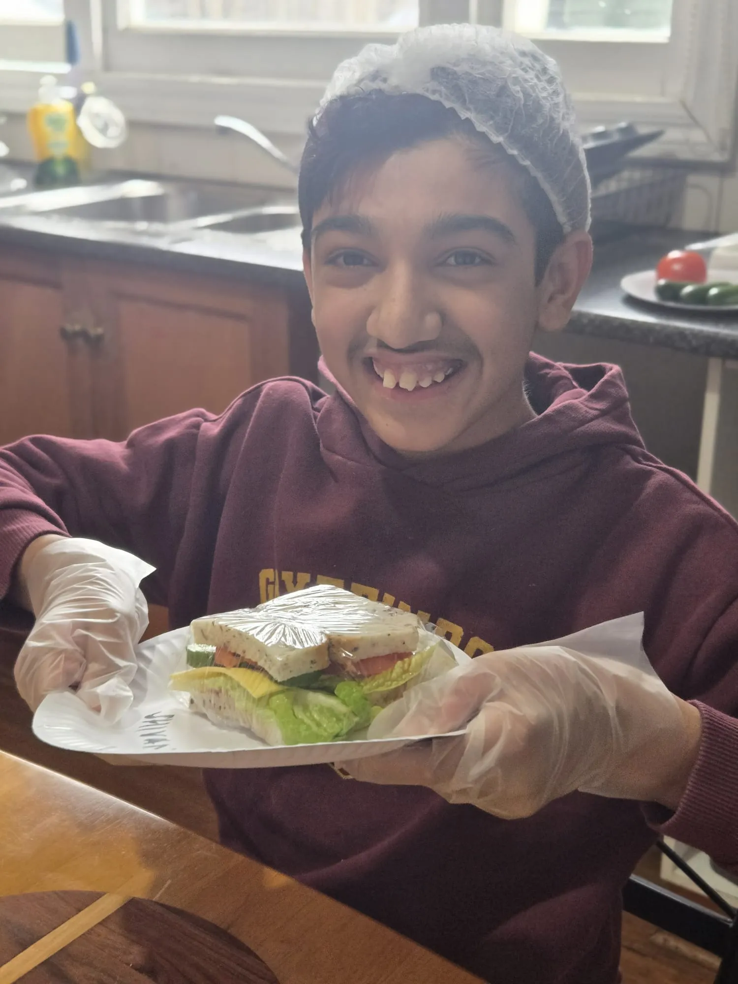 Participants preparing sandwiches together during a cooking and life skills session
