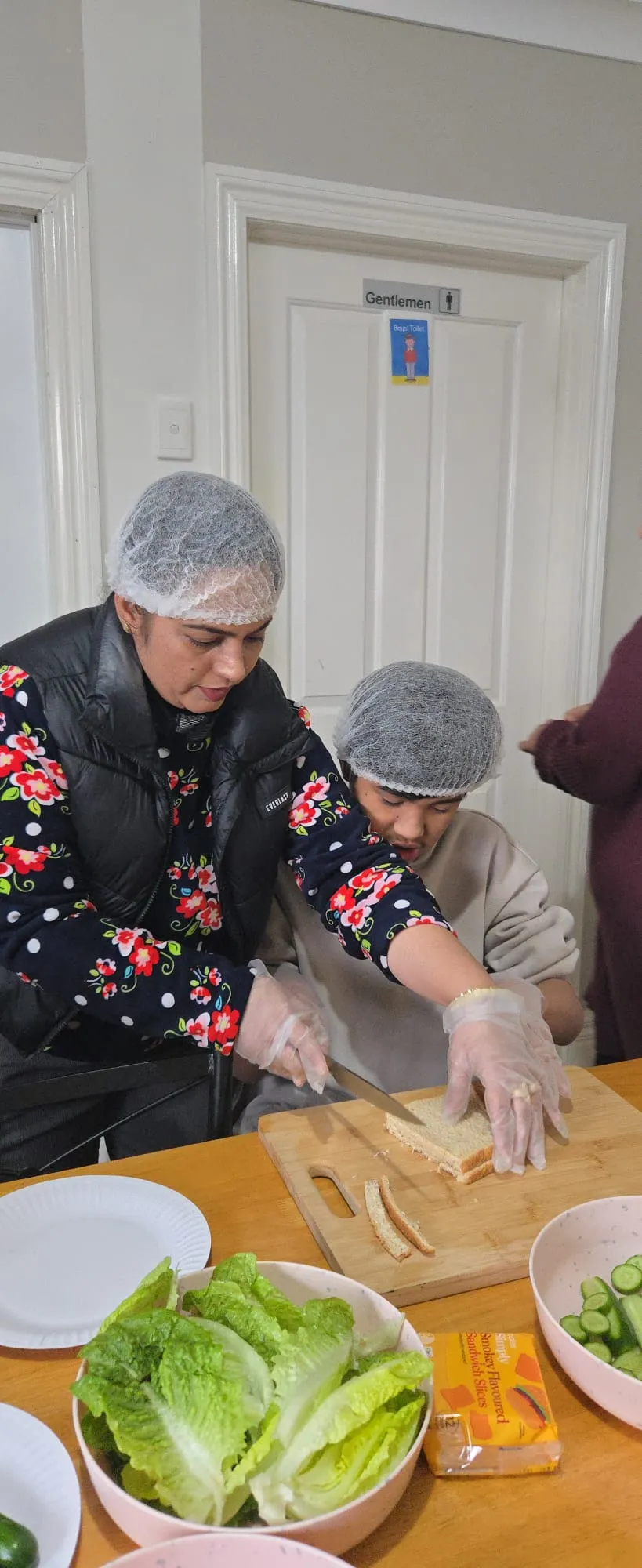 Participants preparing sandwiches together during a cooking and life skills session