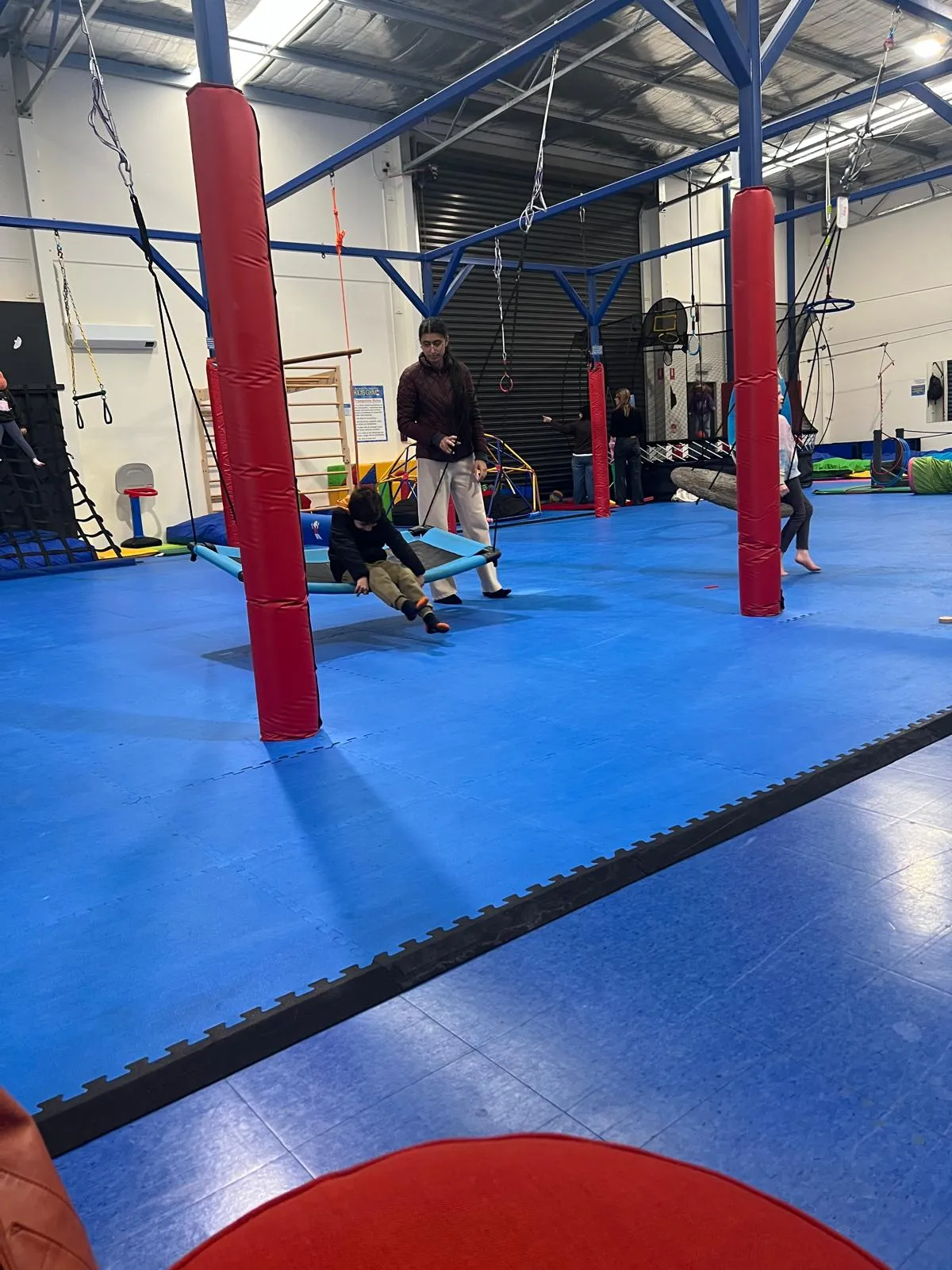 A participant in a group activity room during an evening program session