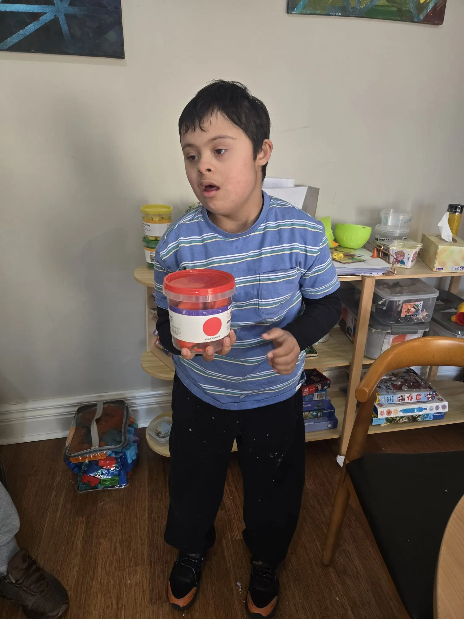 A participant exploring kinetic sand as a sensory play activity
