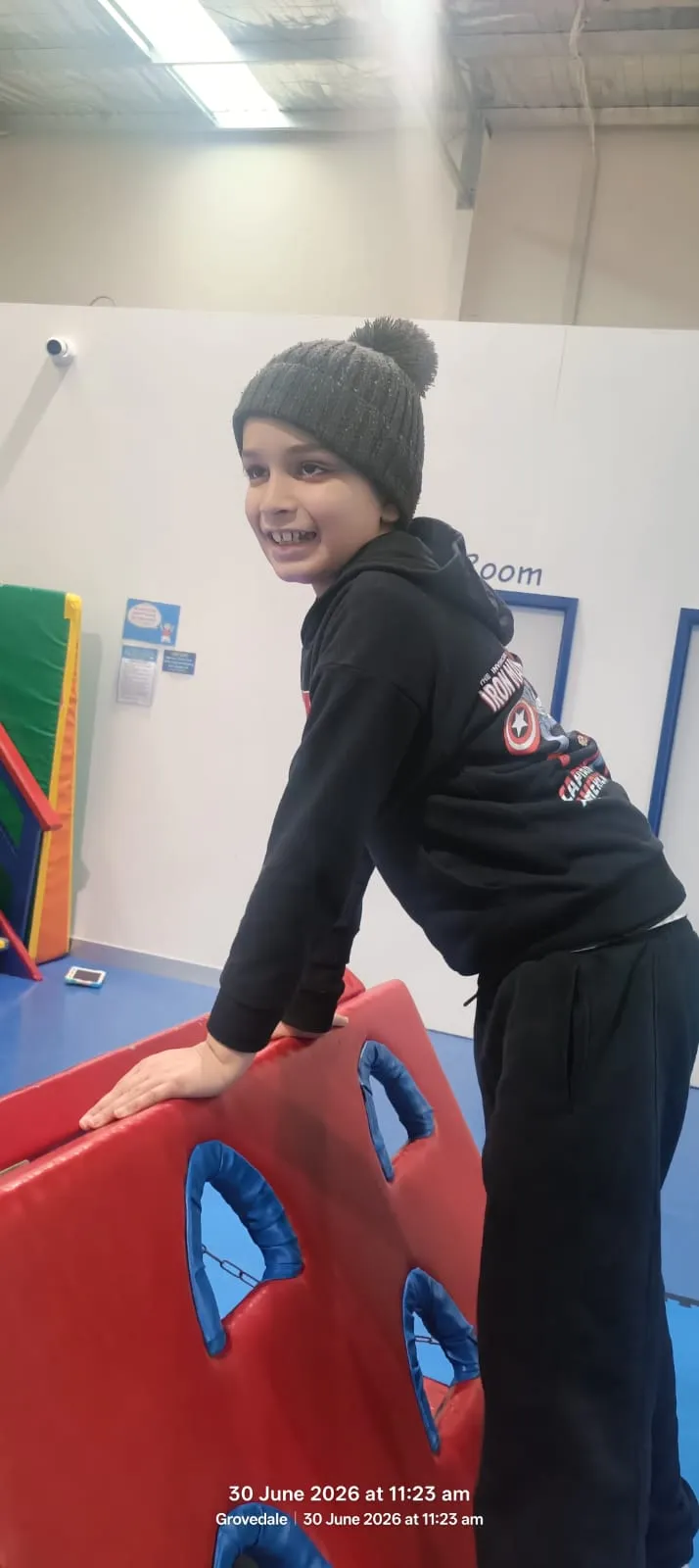 A participant using sensory swing equipment during an occupational therapy session