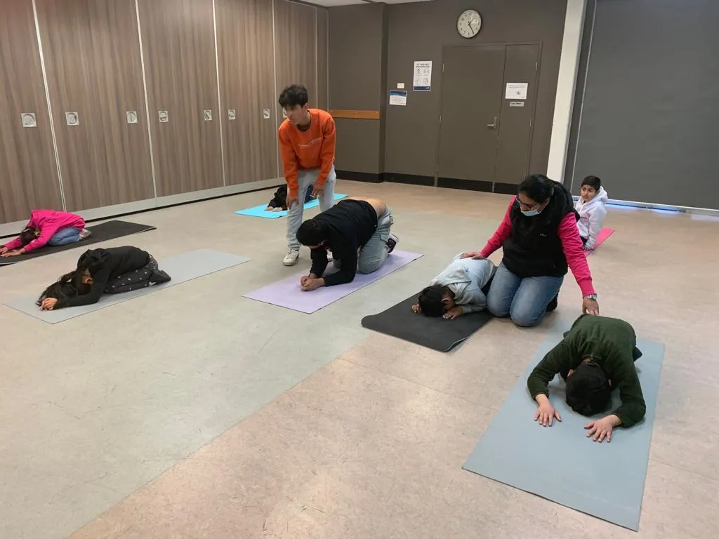 Participants stretching on yoga mats during a guided movement session